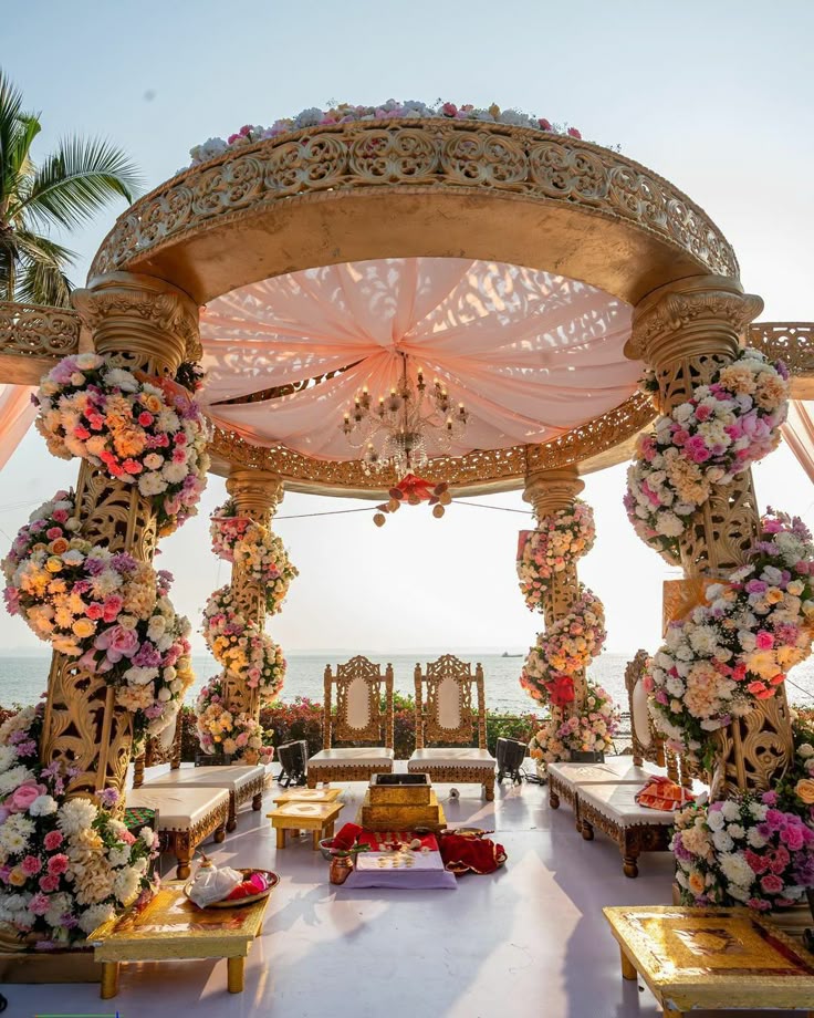 Luxury ceremony mandap with floral pillars by the sea