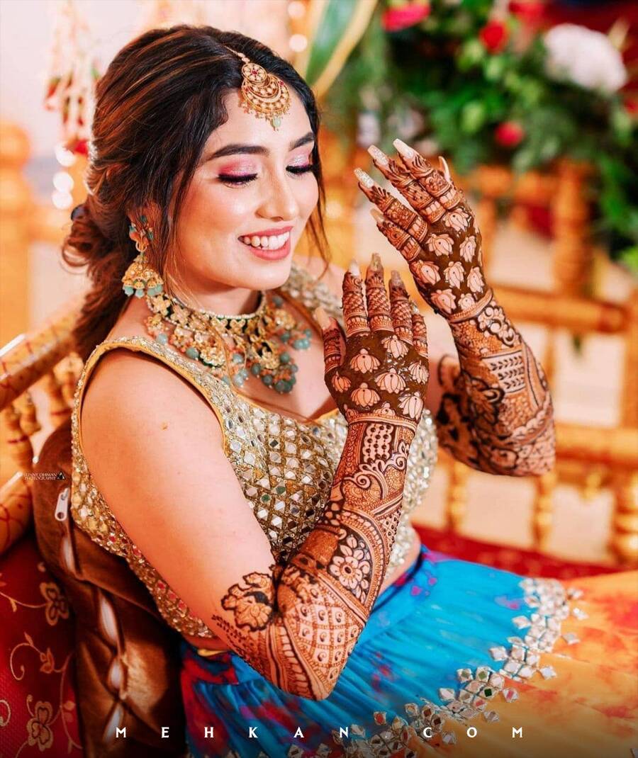 Bride showcasing intricate bridal mehendi design